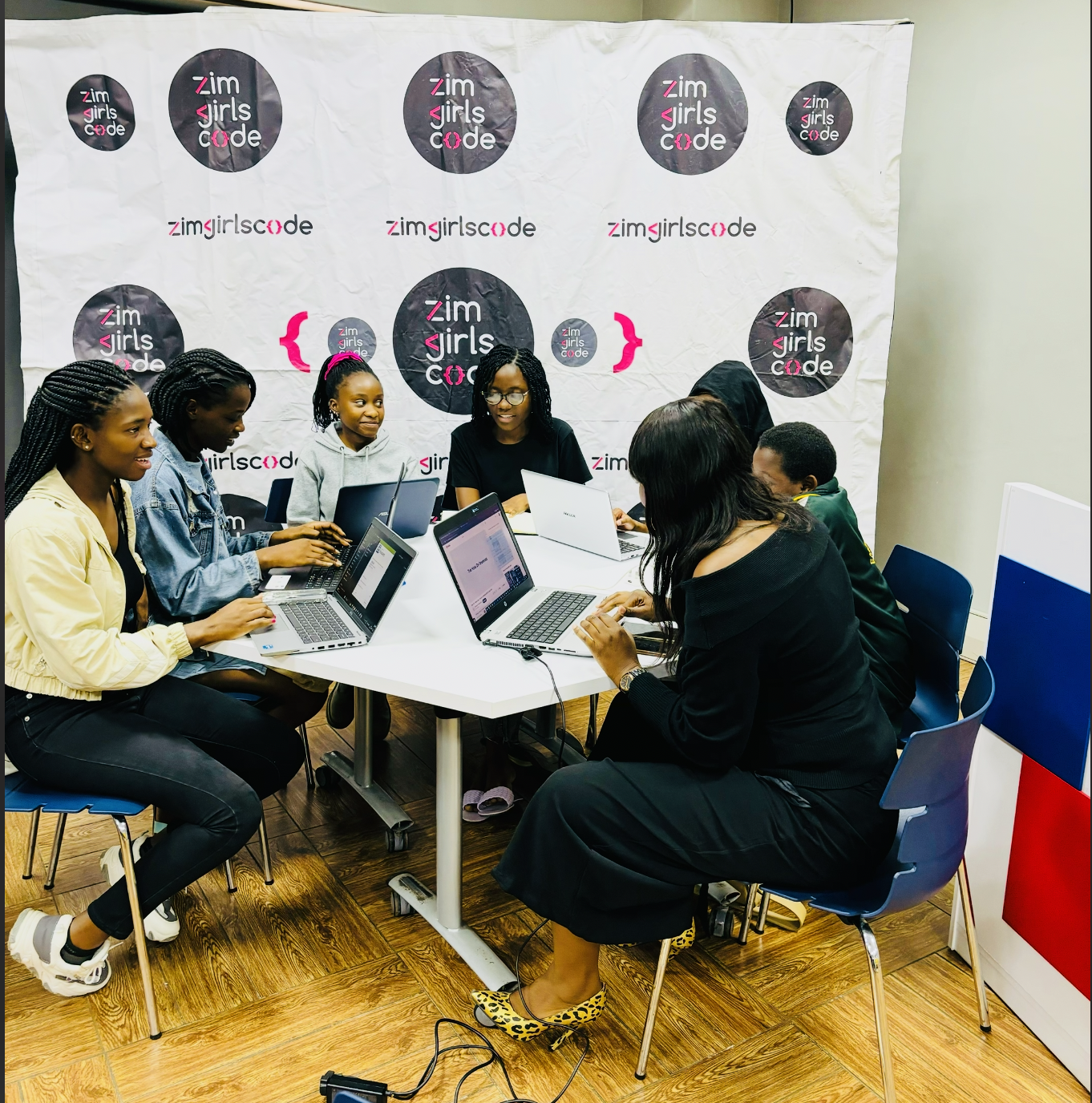 Young women collaborating on coding projects at a ZimGirlsCode workshop